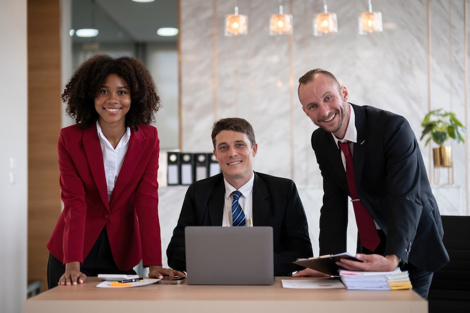 A team of lawyers smiling to camera